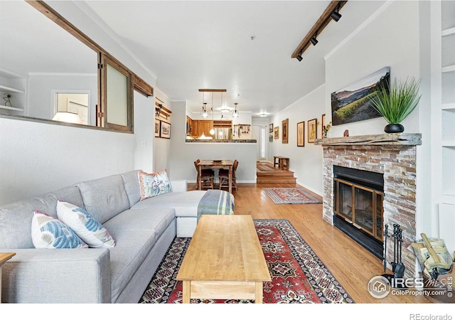 854 Walnut St Unit B, Boulder, CO 80302 - living area with light wood-type flooring, a stone fireplace, and track lighting