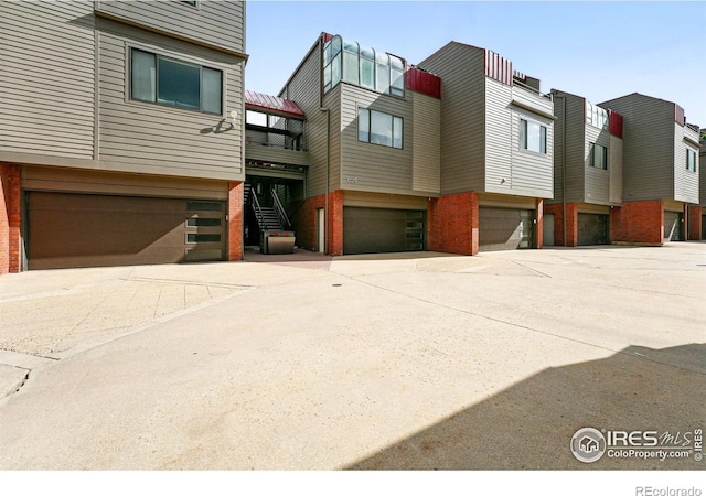 854 Walnut St Unit B, Boulder, CO 80302 - view of building exterior with an attached garage, stairway, and driveway
