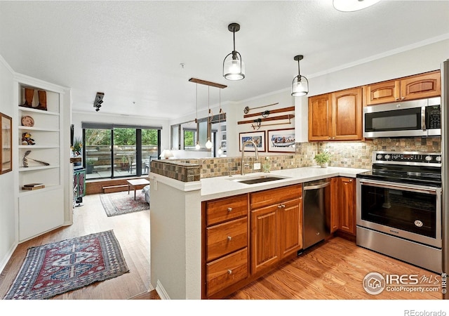 854 Walnut St Unit B, Boulder, CO 80302 - kitchen featuring appliances with stainless steel finishes, light wood finished floors, open floor plan, brown cabinets, and backsplash
