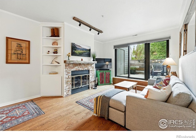 854 Walnut St Unit B, Boulder, CO 80302 - living area featuring wood finished floors, ornamental molding, a fireplace, and built in shelves