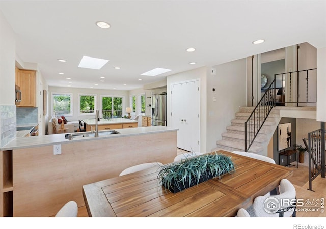 2016 Strathmore St, Louisville, CO 80027 - dining space featuring a skylight, recessed lighting, and stairs