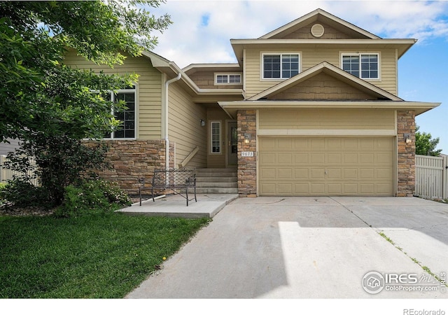 9673 Roadrunner Ave, Firestone, CO 80504 - view of front of home featuring stone siding, concrete driveway, and an attached garage