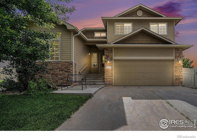 9673 Roadrunner Ave, Firestone, CO 80504 - view of front facade featuring stone siding, driveway, and an attached garage