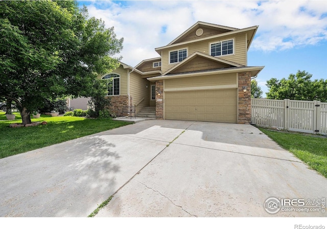 9673 Roadrunner Ave, Firestone, CO 80504 - view of front facade with driveway, stone siding, and a gate