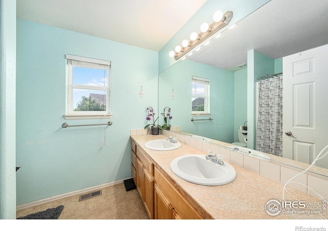 9673 Roadrunner Ave, Firestone, CO 80504 - bathroom with baseboards and double vanity