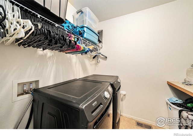 9673 Roadrunner Ave, Firestone, CO 80504 - laundry area featuring washing machine and clothes dryer and a baseboard radiator