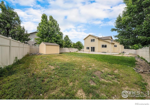 9673 Roadrunner Ave, Firestone, CO 80504 - fenced backyard with a storage unit and a patio area