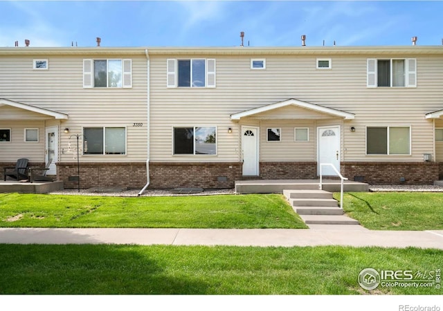 3350 Saratoga St Unit C, Wellington, CO 80549 - multi unit property with brick siding and a front yard
