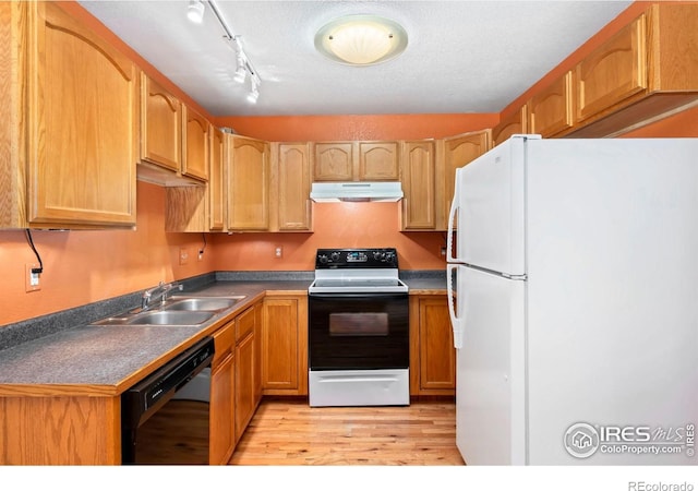 3350 Saratoga St Unit C, Wellington, CO 80549 - kitchen with freestanding refrigerator, range with electric stovetop, black dishwasher, under cabinet range hood, and light wood finished floors