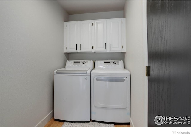 1250 Honeysuckle Ct, Windsor, CO 80550 - laundry area with washing machine and dryer, cabinet space, and light wood-type flooring
