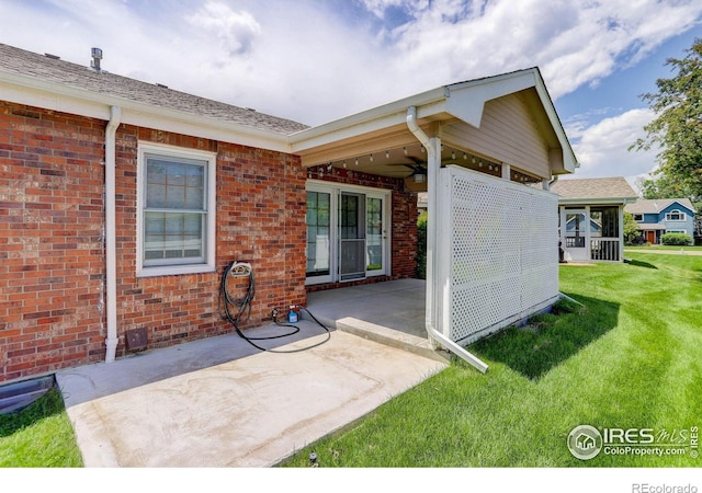 1250 Honeysuckle Ct, Windsor, CO 80550 - back of property with a patio area, a yard, and brick siding