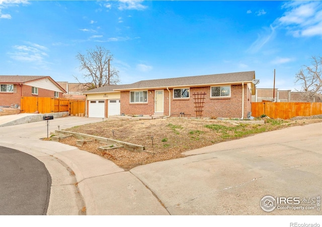 7162 Quay St, Arvada, CO 80003 - ranch-style home with concrete driveway, brick siding, and a garage
