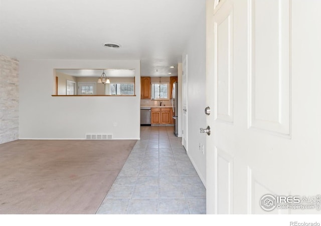 7162 Quay St, Arvada, CO 80003 - foyer featuring light tile patterned floors and light carpet