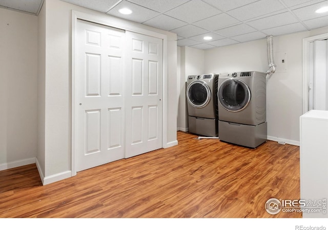 7162 Quay St, Arvada, CO 80003 - laundry room featuring washing machine and clothes dryer, light wood-style floors, and recessed lighting