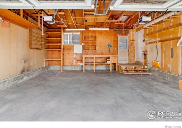 7162 Quay St, Arvada, CO 80003 - garage with a garage door opener and a workshop area