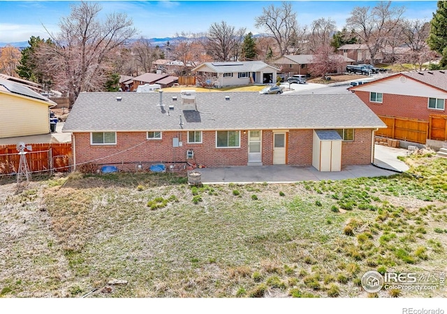 7162 Quay St, Arvada, CO 80003 - rear view of property with a patio, a fenced backyard, a residential view, and brick siding