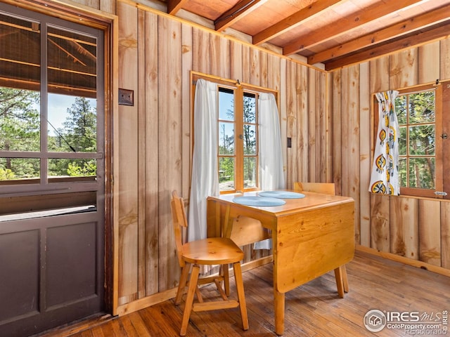 84 County Road 113 N, Allenspark, CO 80510 - dining space featuring wood walls, hardwood / wood-style floors, and beam ceiling