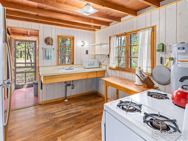 84 County Road 113 N, Allenspark, CO 80510 - kitchen featuring white appliances, hardwood / wood-style floors, a wooden ceiling with exposed beams, wood walls, and light countertops