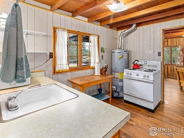 84 County Road 113 N, Allenspark, CO 80510 - kitchen featuring white range with gas stovetop, water heater, a wood ceiling with exposed beams, wood walls, and hardwood / wood-style floors