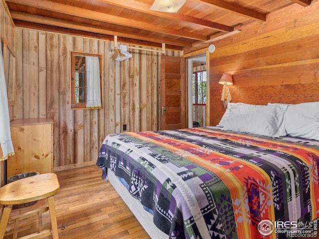 84 County Road 113 N, Allenspark, CO 80510 - bedroom with a wood ceiling with exposed beams, wood walls, and light wood-style flooring