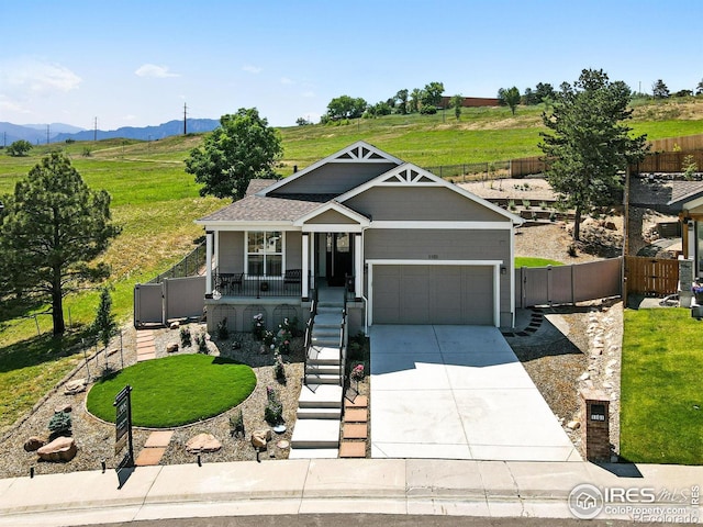 1101 Hillside Ln, Louisville, CO 80027 - craftsman house featuring covered porch, a gate, driveway, a garage, and a mountain view