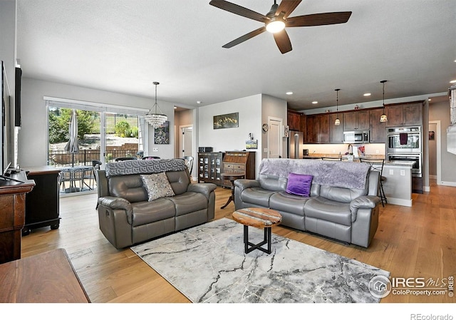 1101 Hillside Ln, Louisville, CO 80027 - living room with ceiling fan, light wood-type flooring, recessed lighting, and a chandelier