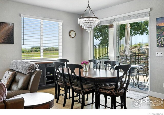 1101 Hillside Ln, Louisville, CO 80027 - dining area featuring a chandelier, light wood-style floors, and healthy amount of natural light