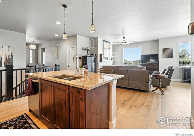 1101 Hillside Ln, Louisville, CO 80027 - kitchen featuring light wood-style flooring, pendant lighting, plenty of natural light, a textured ceiling, and recessed lighting