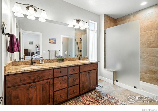 1101 Hillside Ln, Louisville, CO 80027 - full bath featuring tiled shower, ensuite bath, double vanity, and tile patterned floors