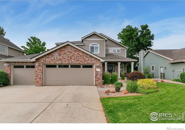 2006 Mackenzie Ct, Fort Collins, CO 80528 - view of front of home with brick siding, a garage, driveway, and a front yard