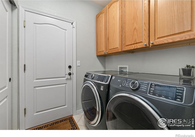 2006 Mackenzie Ct, Fort Collins, CO 80528 - washroom featuring cabinet space, separate washer and dryer, and light tile patterned flooring