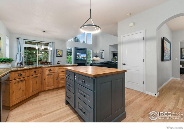 2006 Mackenzie Ct, Fort Collins, CO 80528 - kitchen with butcher block counters, light wood-style floors, arched walkways, and stainless steel dishwasher