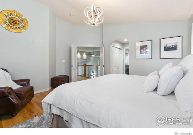 2006 Mackenzie Ct, Fort Collins, CO 80528 - bedroom with wood finished floors, a chandelier, arched walkways, and a closet