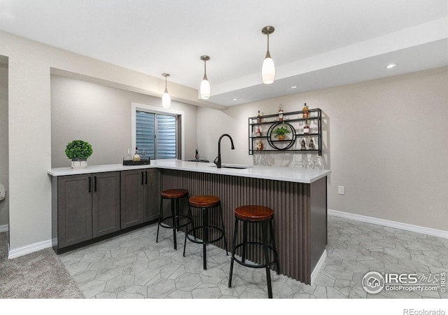 2006 Mackenzie Ct, Fort Collins, CO 80528 - kitchen with light countertops, a kitchen breakfast bar, pendant lighting, recessed lighting, and a peninsula