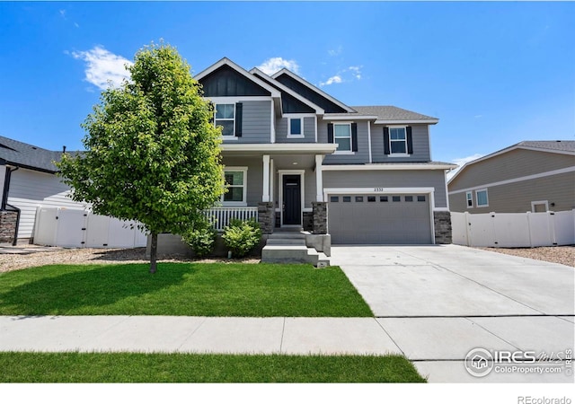 2332 Tabor St, Berthoud, CO 80513 - craftsman-style house with a garage, concrete driveway, a gate, stone siding, and a porch