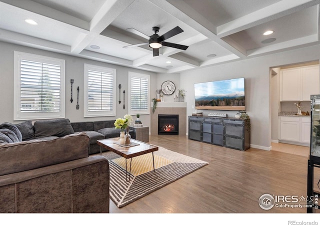2332 Tabor St, Berthoud, CO 80513 - living area with coffered ceiling, ceiling fan, light wood finished floors, a tile fireplace, and beam ceiling