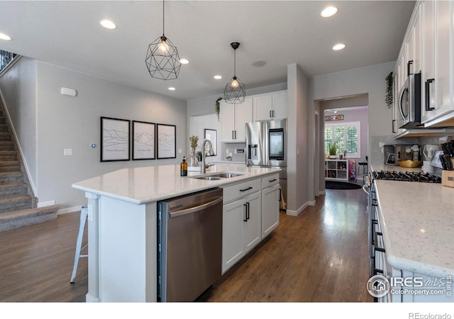 2332 Tabor St, Berthoud, CO 80513 - kitchen with stainless steel appliances, dark wood-style floors, white cabinets, recessed lighting, and light stone countertops