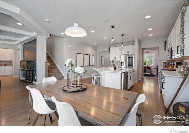2332 Tabor St, Berthoud, CO 80513 - dining space featuring dark wood-type flooring, recessed lighting, stairs, and beamed ceiling