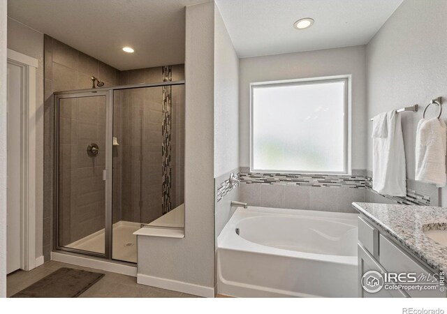 2332 Tabor St, Berthoud, CO 80513 - full bath featuring a shower stall, a bath, vanity, tile patterned flooring, and recessed lighting