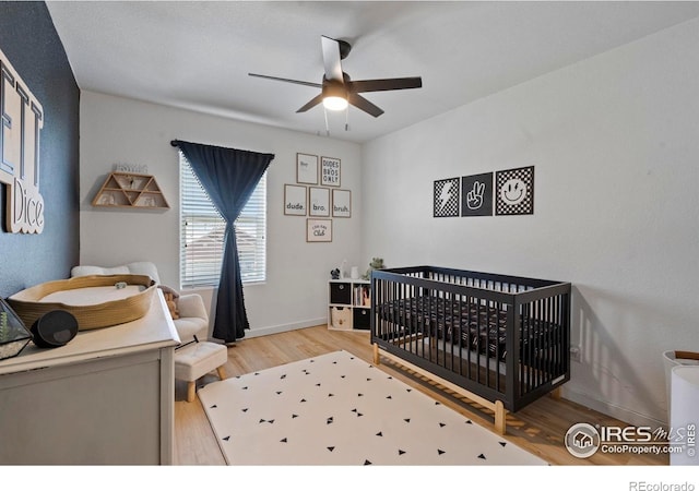 2332 Tabor St, Berthoud, CO 80513 - bedroom with light wood-style flooring, a nursery area, and a ceiling fan