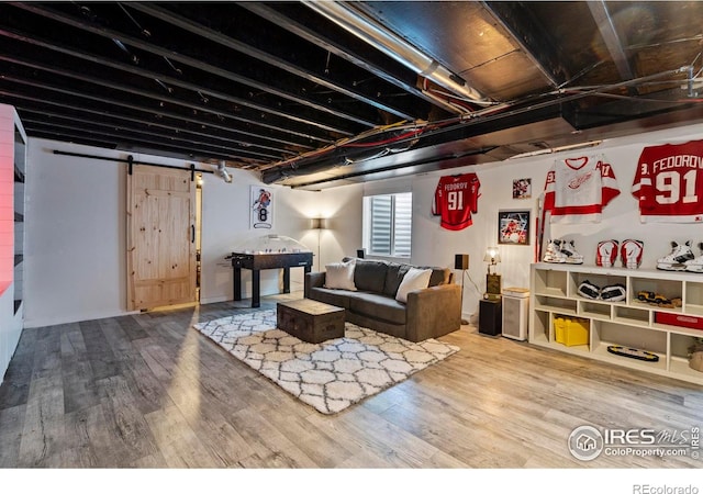 2332 Tabor St, Berthoud, CO 80513 - living area with wood finished floors and a barn door