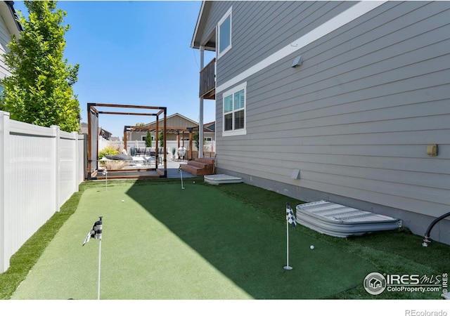 2332 Tabor St, Berthoud, CO 80513 - fenced backyard with a putting area, a gazebo, and a patio area