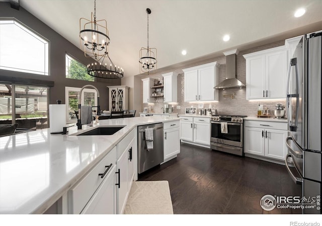 4041 Carroway Seed Dr, Johnstown, CO 80534 - kitchen with stainless steel appliances, wall chimney exhaust hood, recessed lighting, white cabinetry, and light countertops