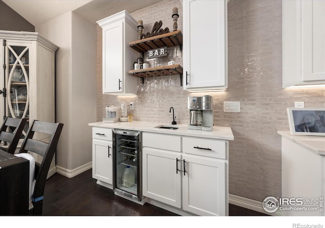 4041 Carroway Seed Dr, Johnstown, CO 80534 - indoor wet bar with wine cooler, dark wood-type flooring, and tasteful backsplash