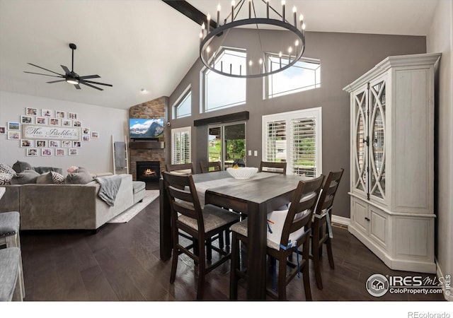 4041 Carroway Seed Dr, Johnstown, CO 80534 - dining area with high vaulted ceiling, a fireplace, dark wood-style flooring, a chandelier, and ceiling fan