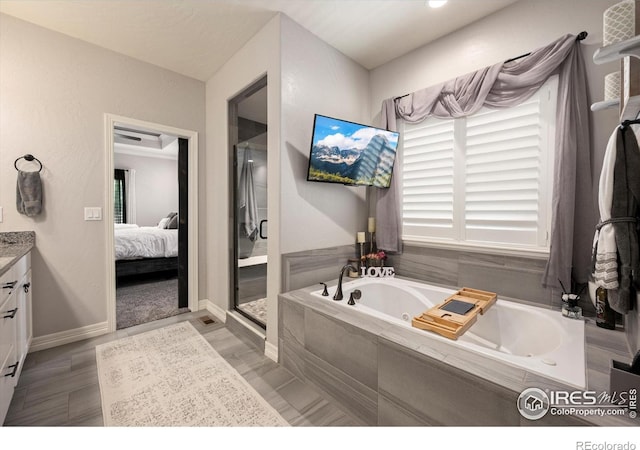 4041 Carroway Seed Dr, Johnstown, CO 80534 - ensuite bathroom featuring vanity, a whirlpool tub, and a shower stall
