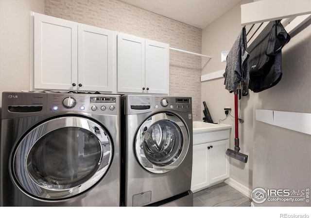 4041 Carroway Seed Dr, Johnstown, CO 80534 - washroom featuring cabinet space and independent washer and dryer