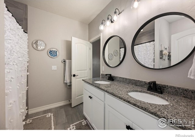 4041 Carroway Seed Dr, Johnstown, CO 80534 - bathroom with double vanity and baseboards