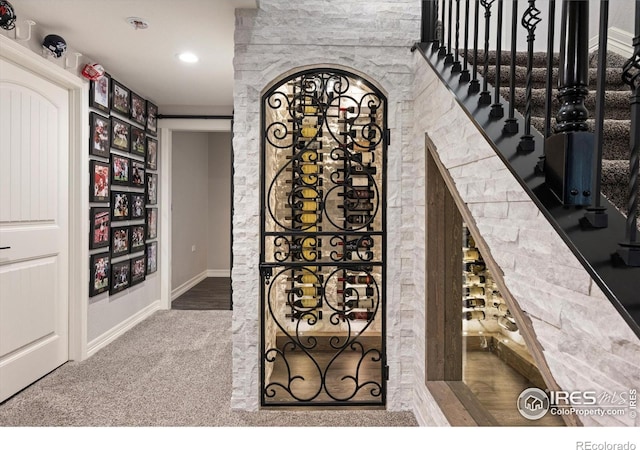 4041 Carroway Seed Dr, Johnstown, CO 80534 - wine area with recessed lighting, arched walkways, and carpet