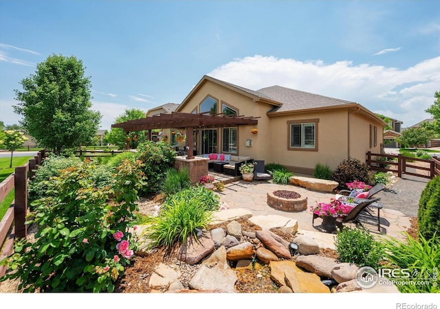 4041 Carroway Seed Dr, Johnstown, CO 80534 - rear view of house with an outdoor living space with a fire pit, stucco siding, a pergola, a patio area, and a fenced backyard